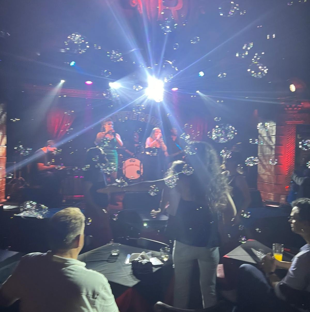 Cassette Unlimited performing live with stage lights and bubbles